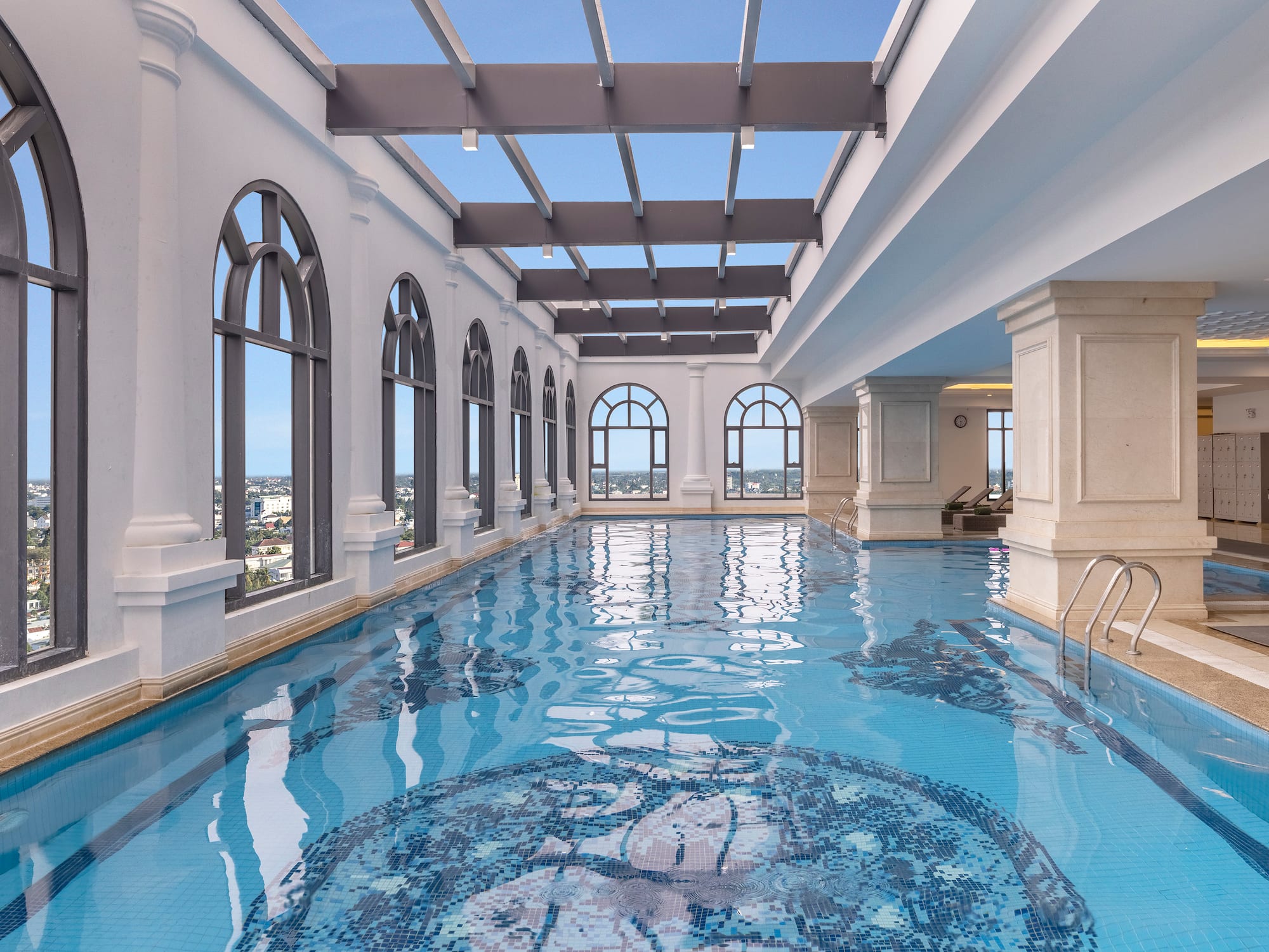 a indoor swimming pool with large windows