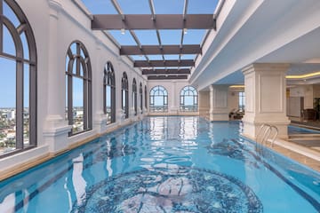 a indoor swimming pool with large windows