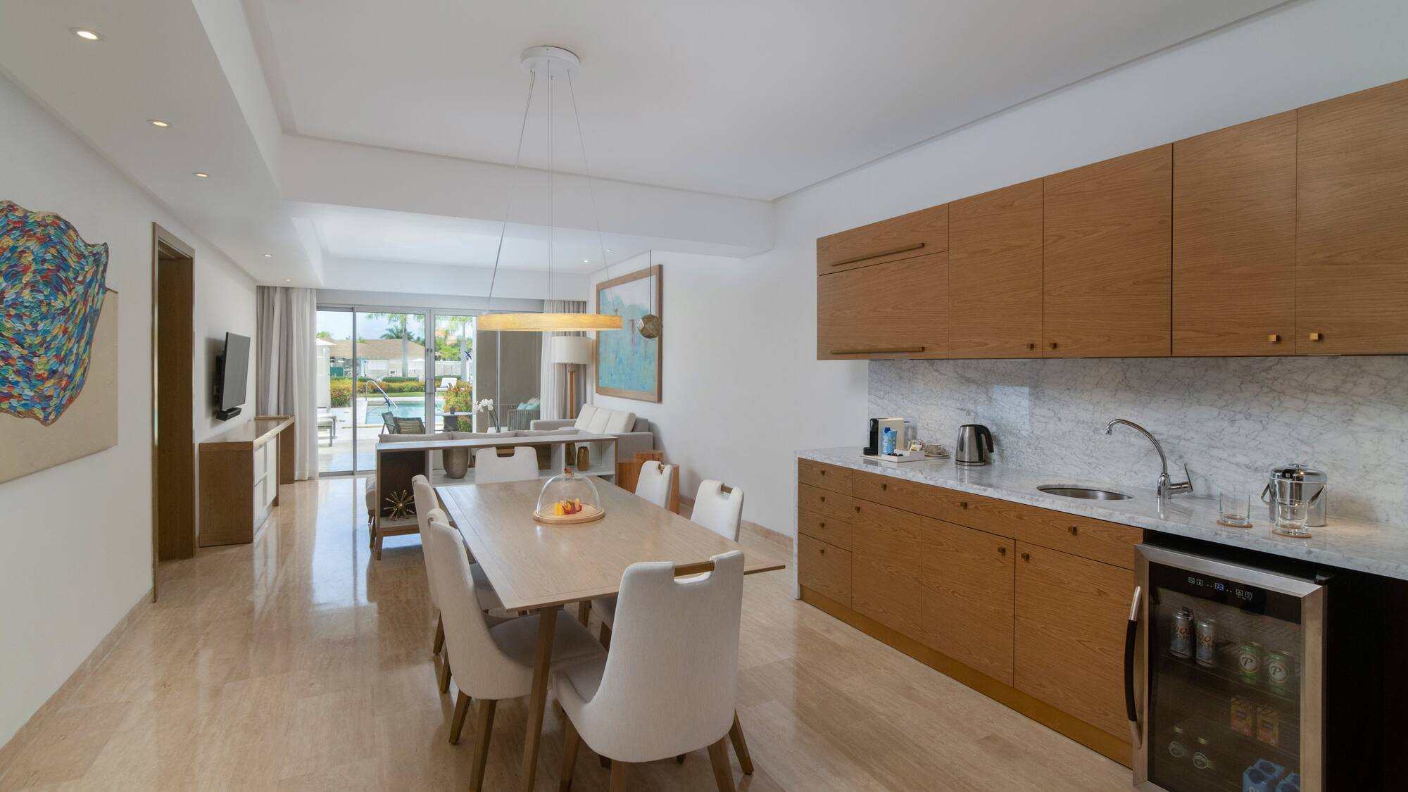 a kitchen and dining room with a table and chairs
