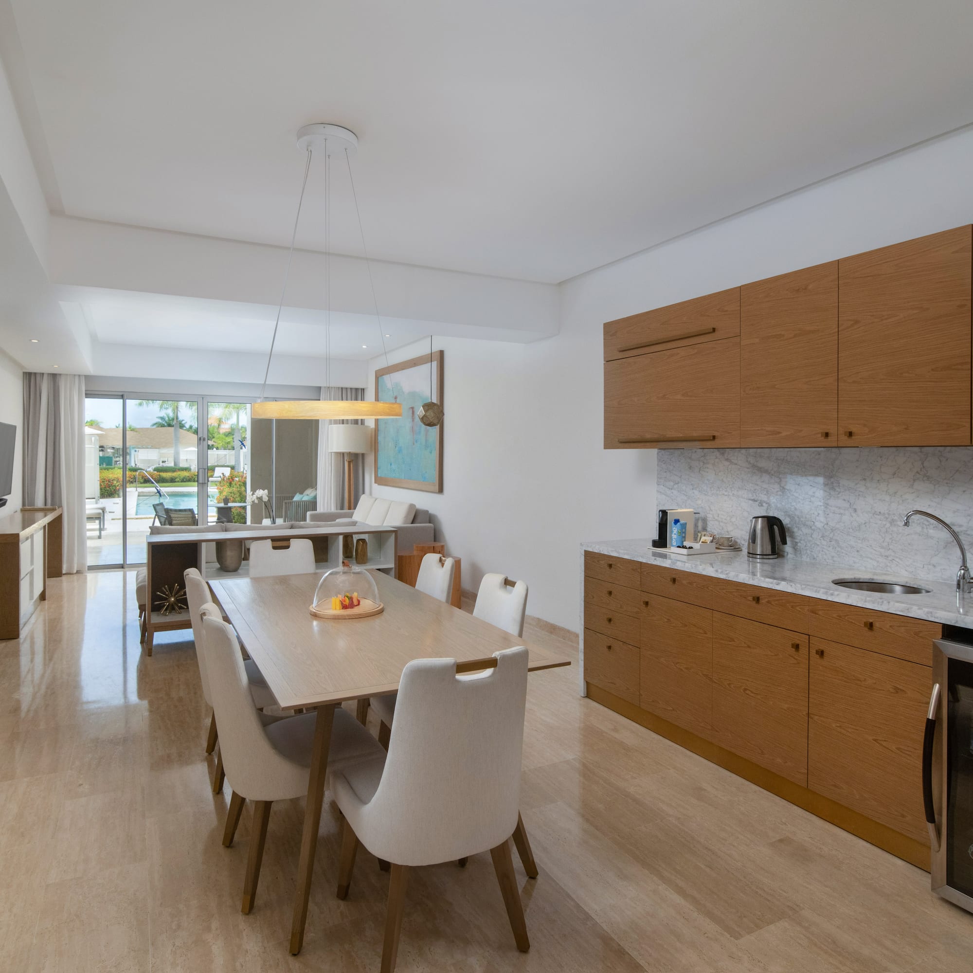 a kitchen and dining room with a table and chairs