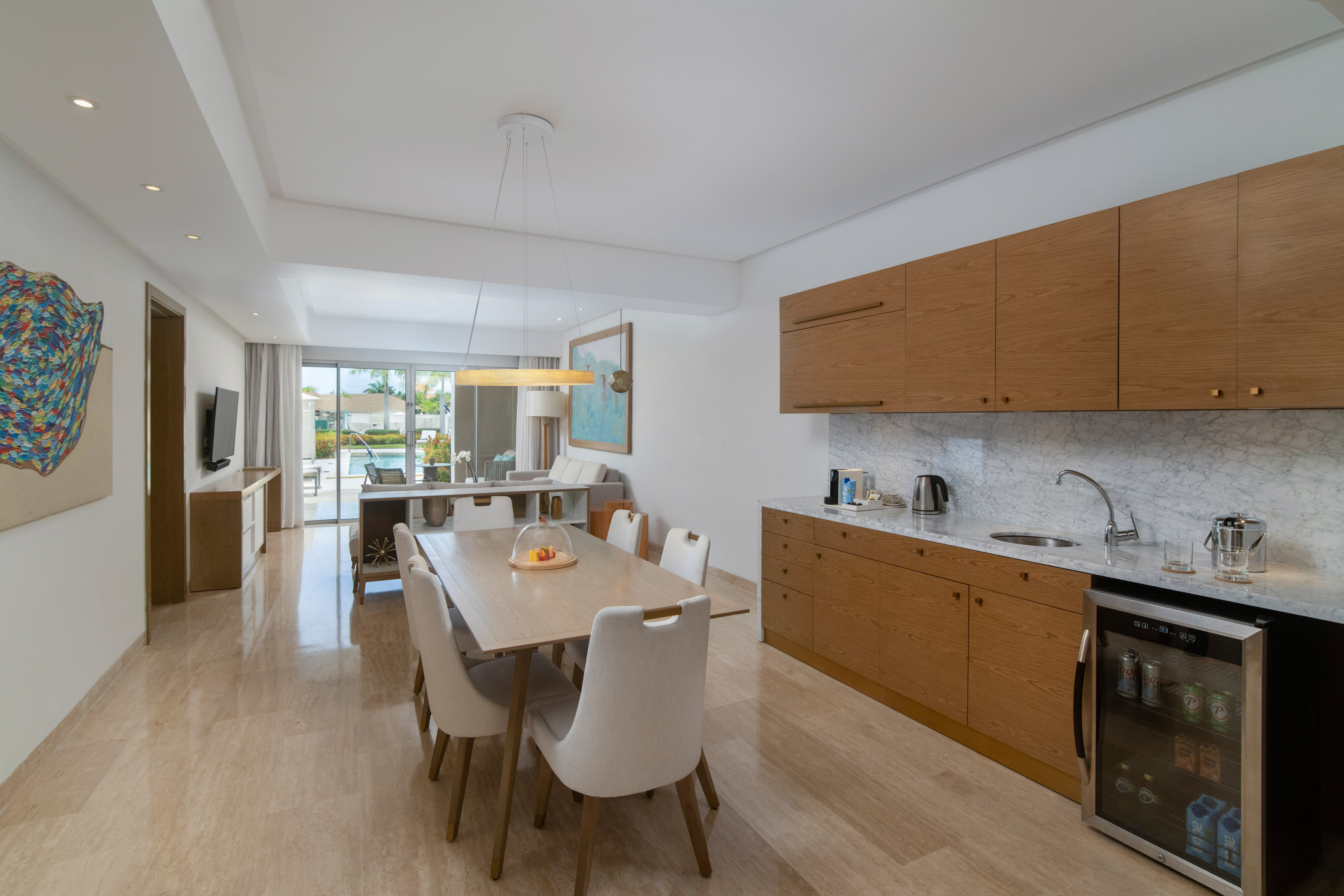 a kitchen and dining room with a table and chairs