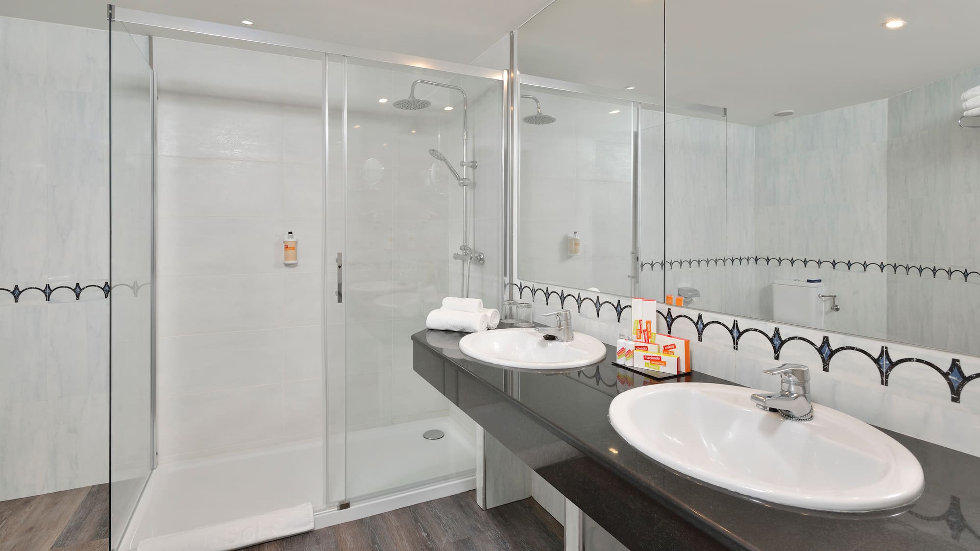 a bathroom with a shower and two sinks