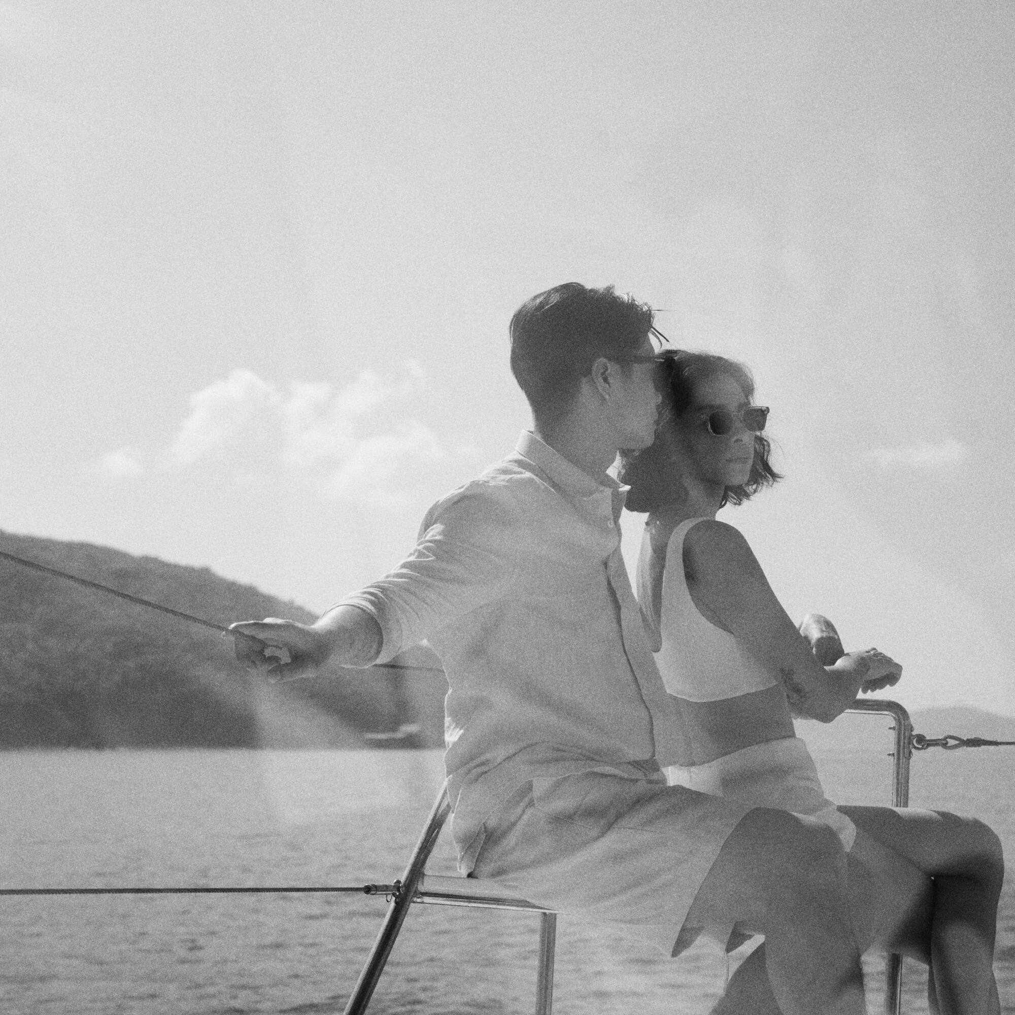 a man and woman sitting on a boat.