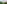 Woman in hat observing misty tropical jungle waterfall.