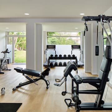a room with exercise equipment and a large window.