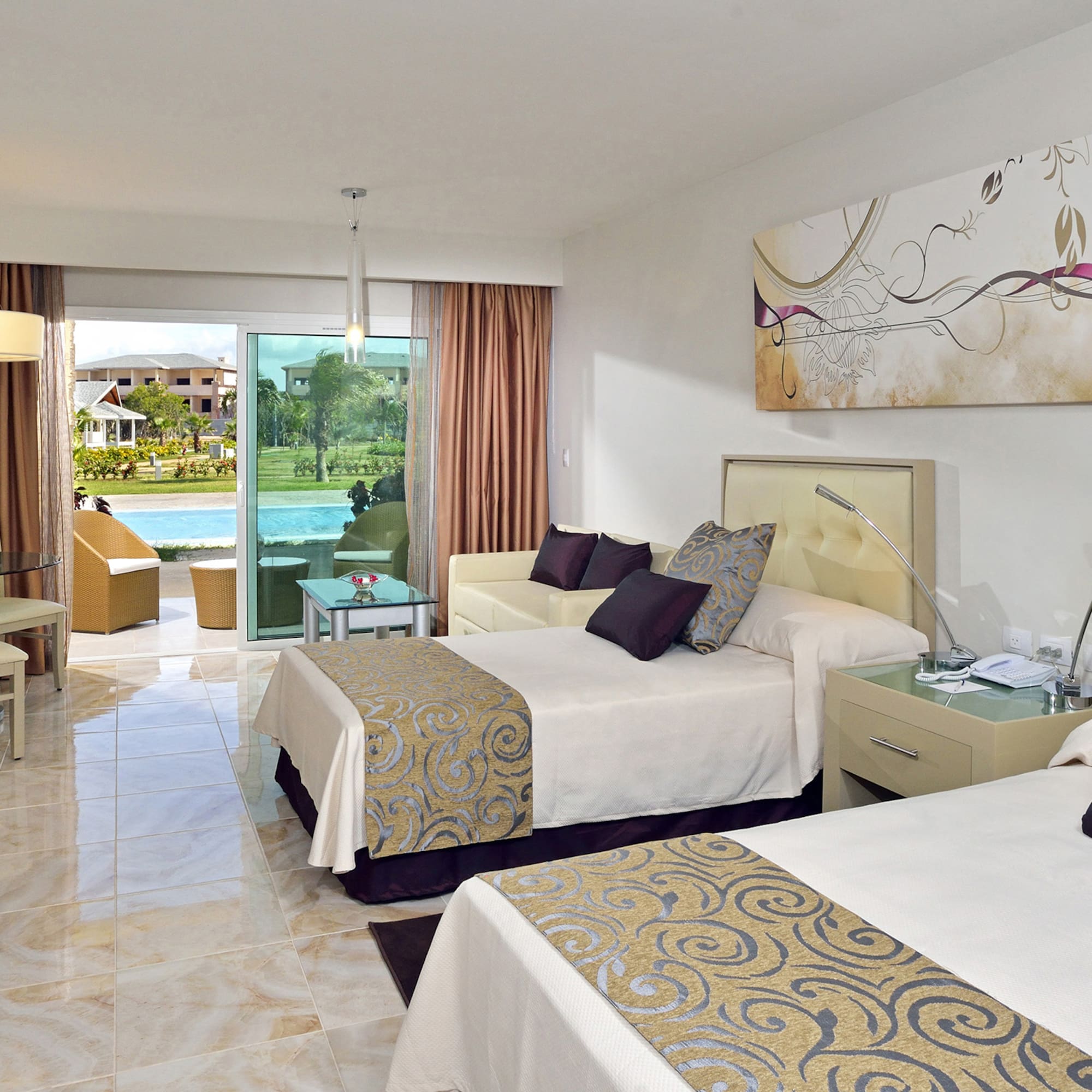 a room with two beds and a pool in the background