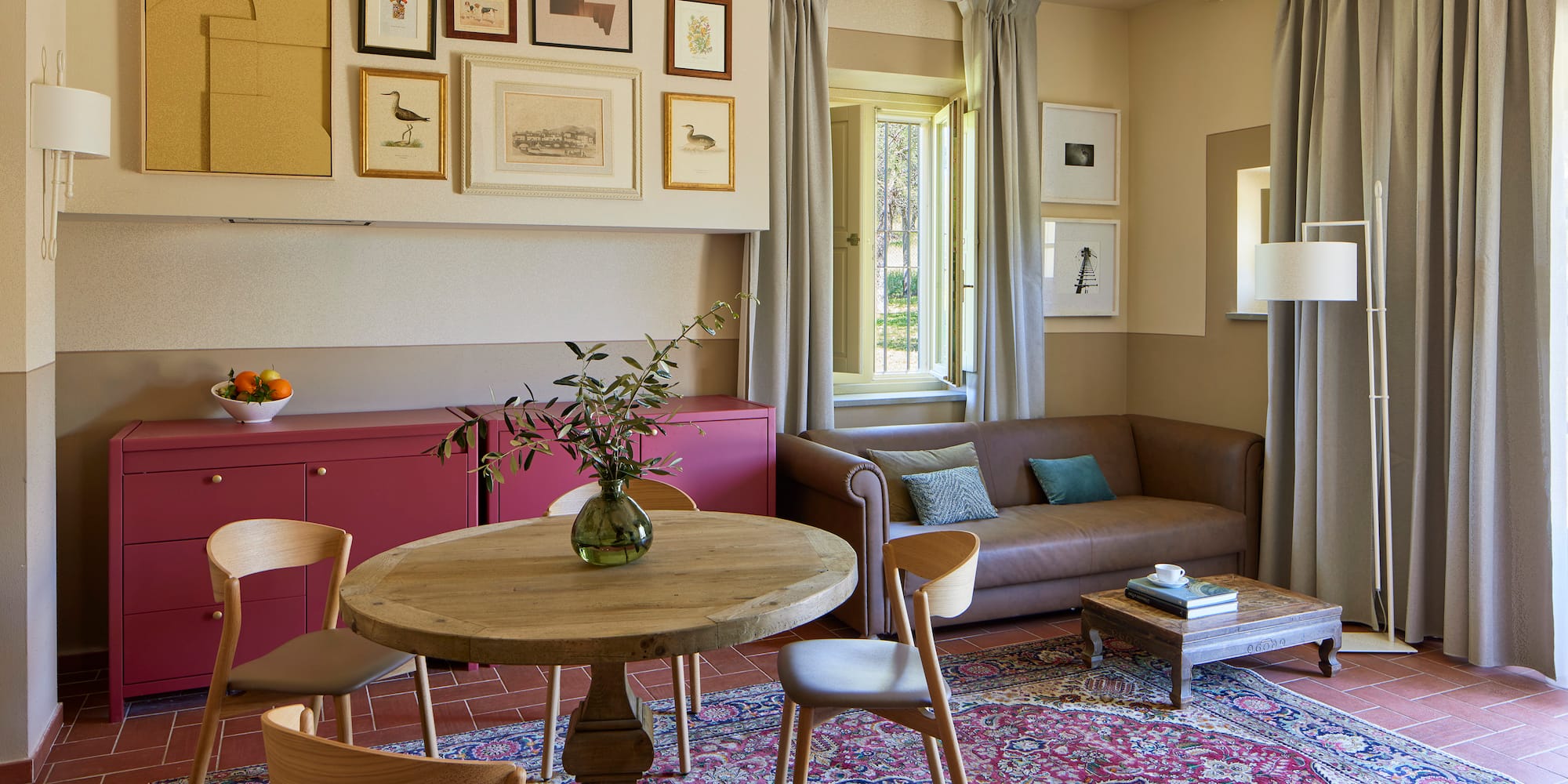 a living room with a table and chairs