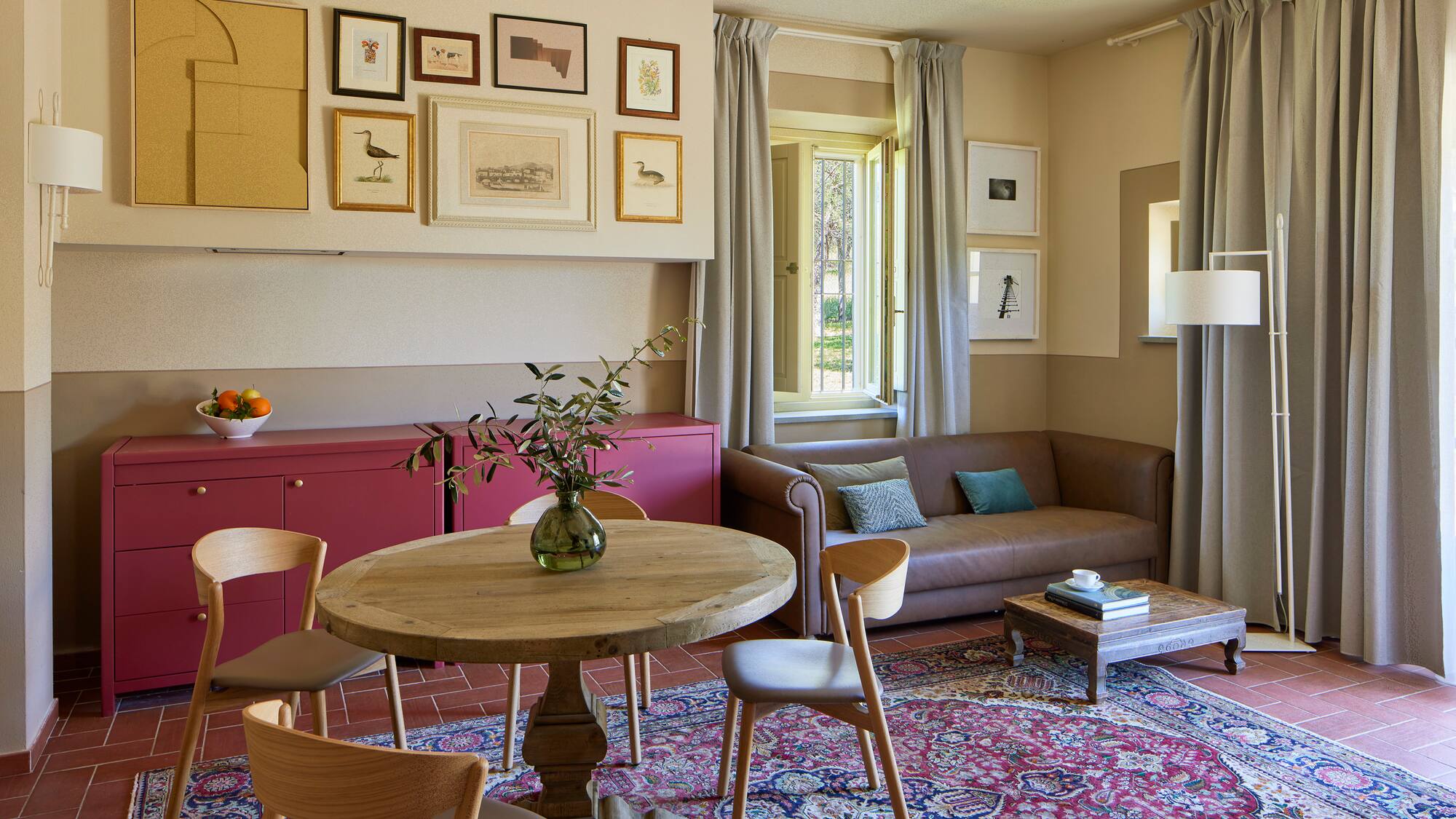 a living room with a table and chairs