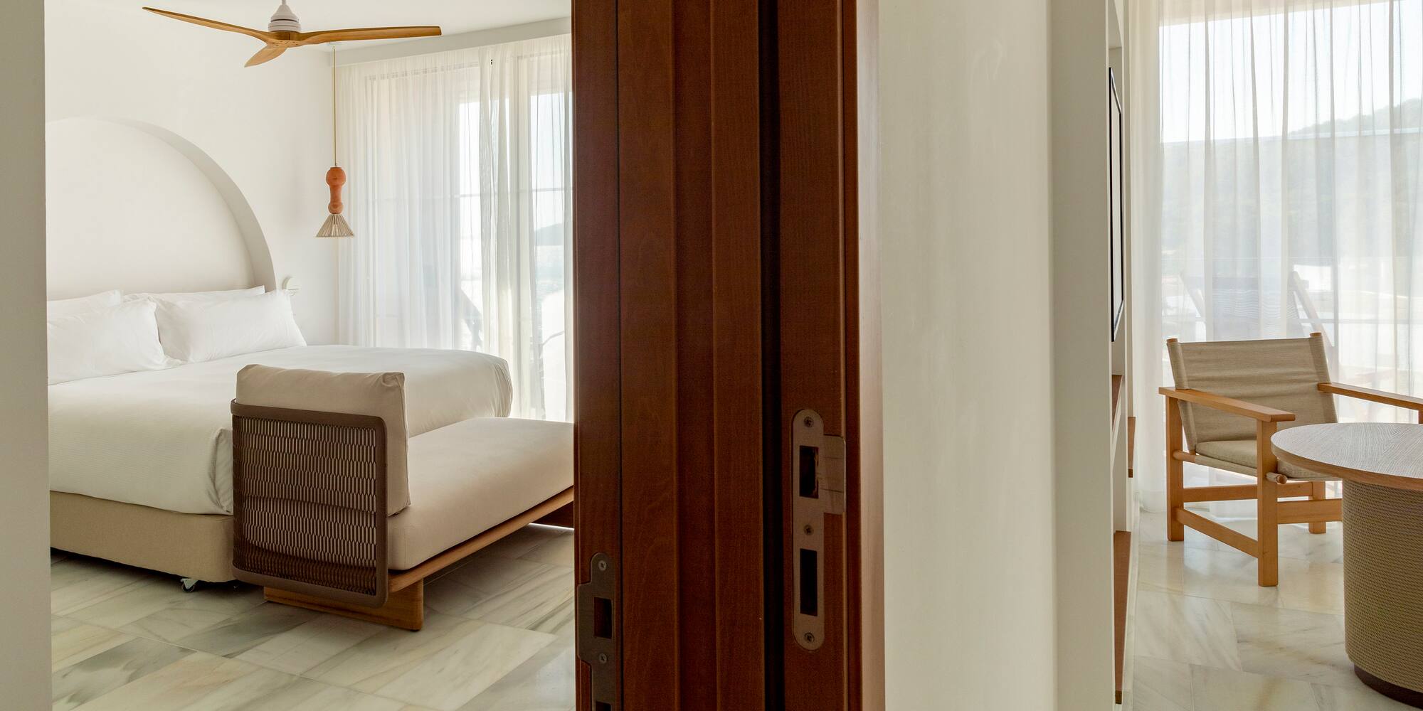 a room with a bed and a ceiling fan