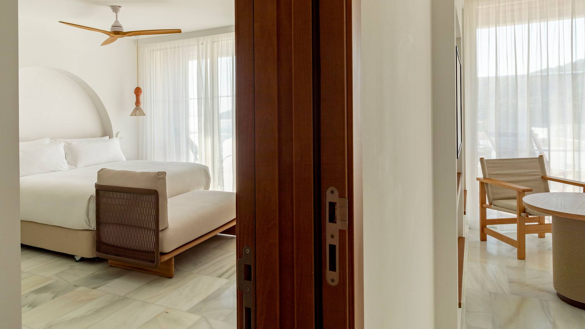 a room with a bed and a ceiling fan