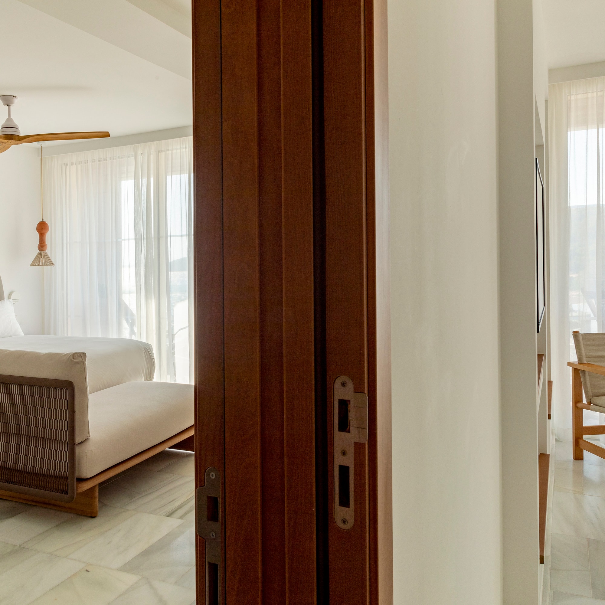 a room with a bed and a ceiling fan