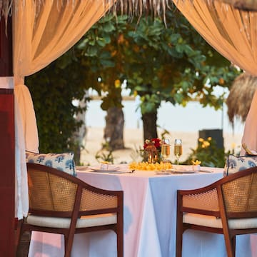 a table with a couple of chairs and a table with a couple of glasses on it