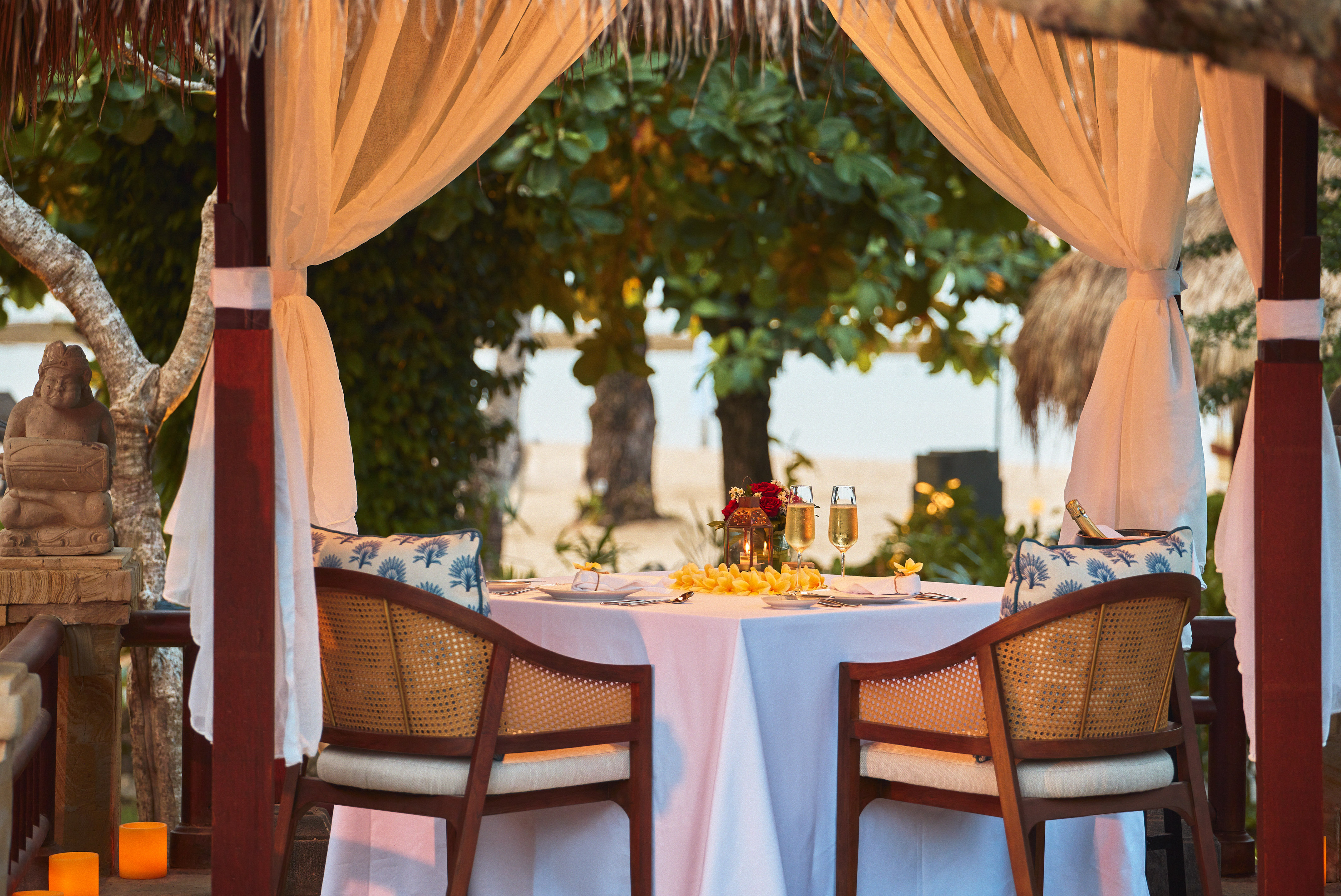 a table with a couple of chairs and a table with a couple of glasses on it