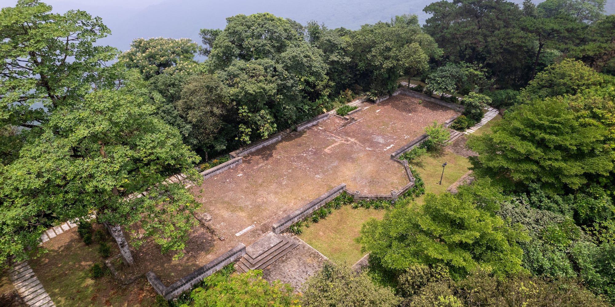 an aerial view of a stone building surrounded by trees