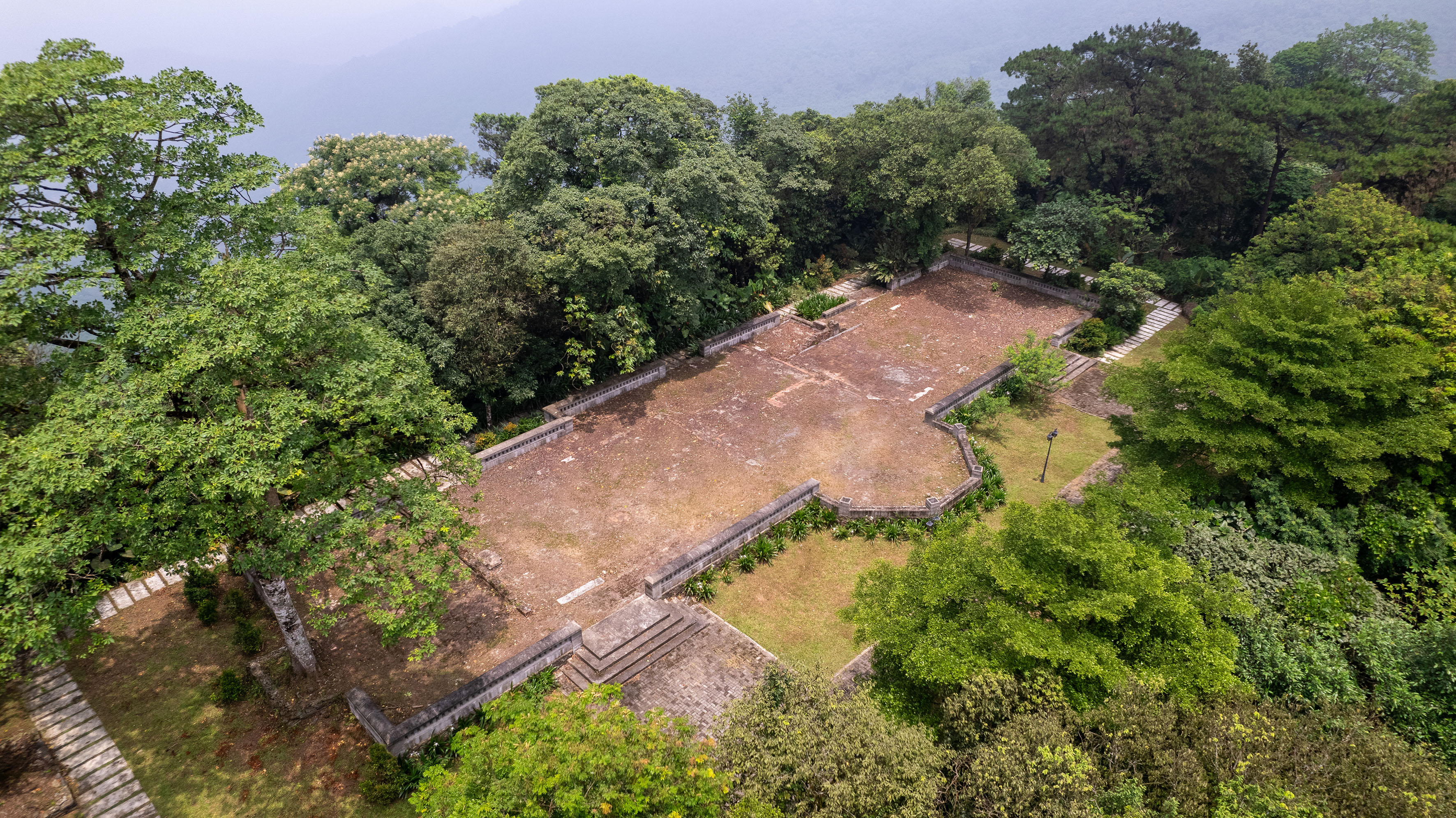 an aerial view of a stone building surrounded by trees
