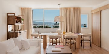a living room with a table and chairs