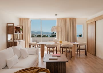 a living room with a table and chairs