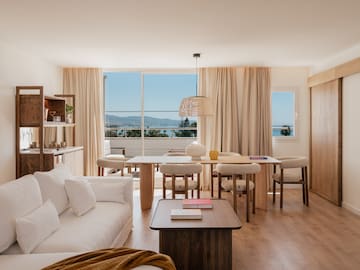 a living room with a table and chairs