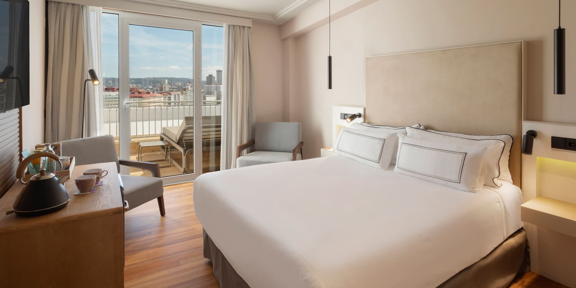 a bedroom with a bed and a desk and chairs