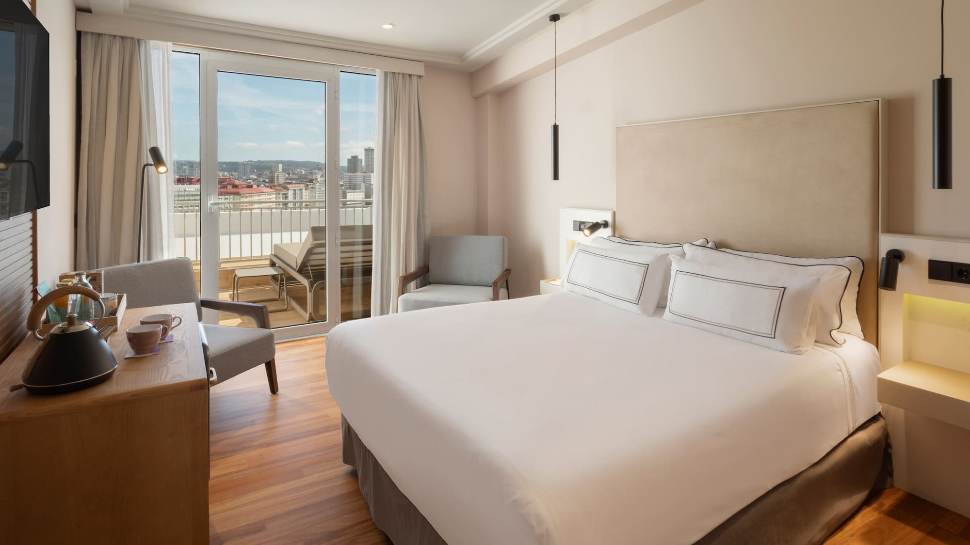 a bedroom with a bed and a desk and chairs