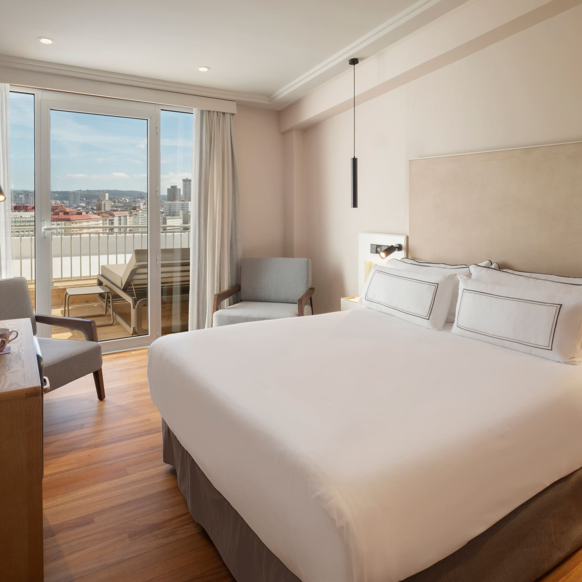 a bedroom with a bed and a desk and chairs