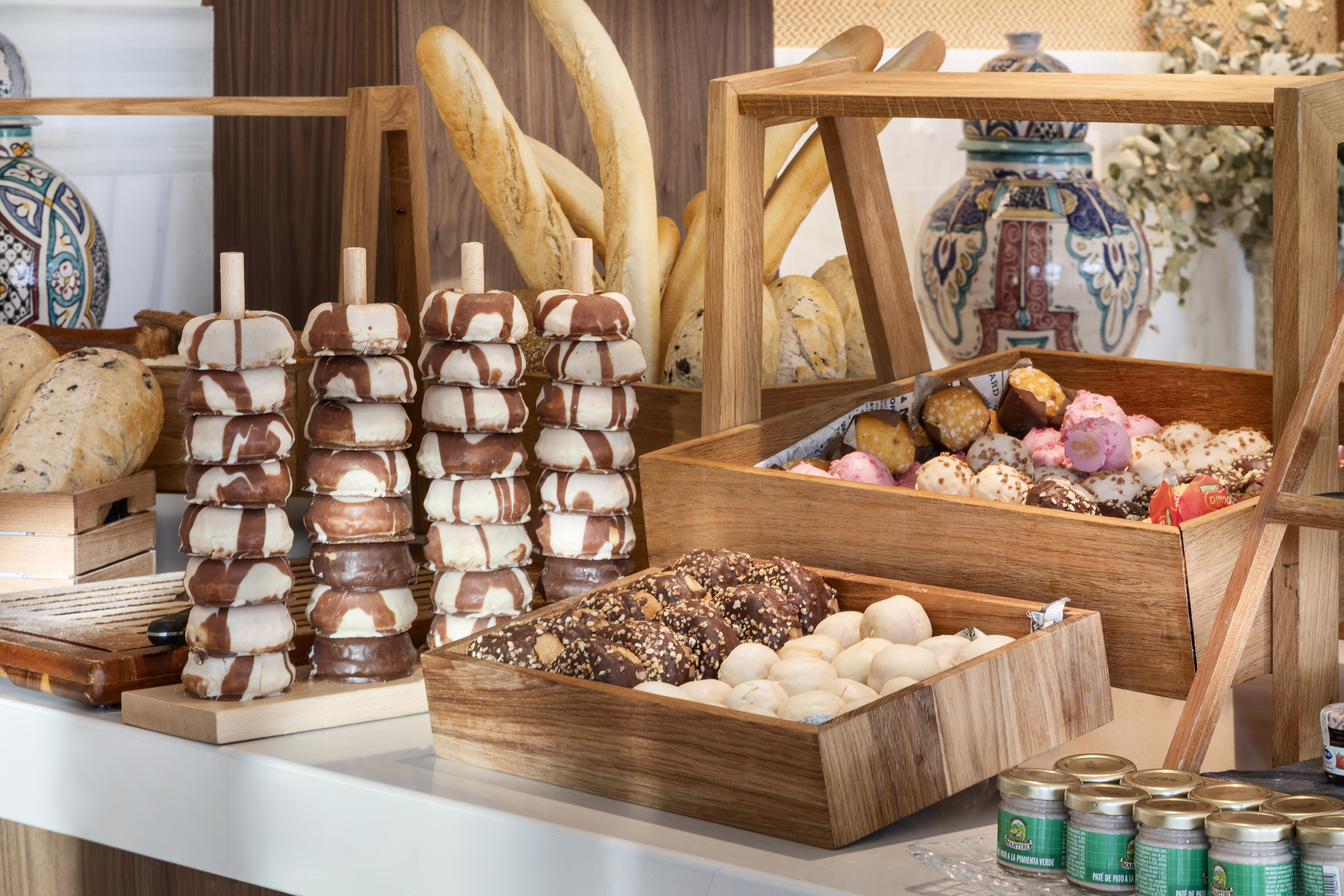 a variety of donuts in wooden containers