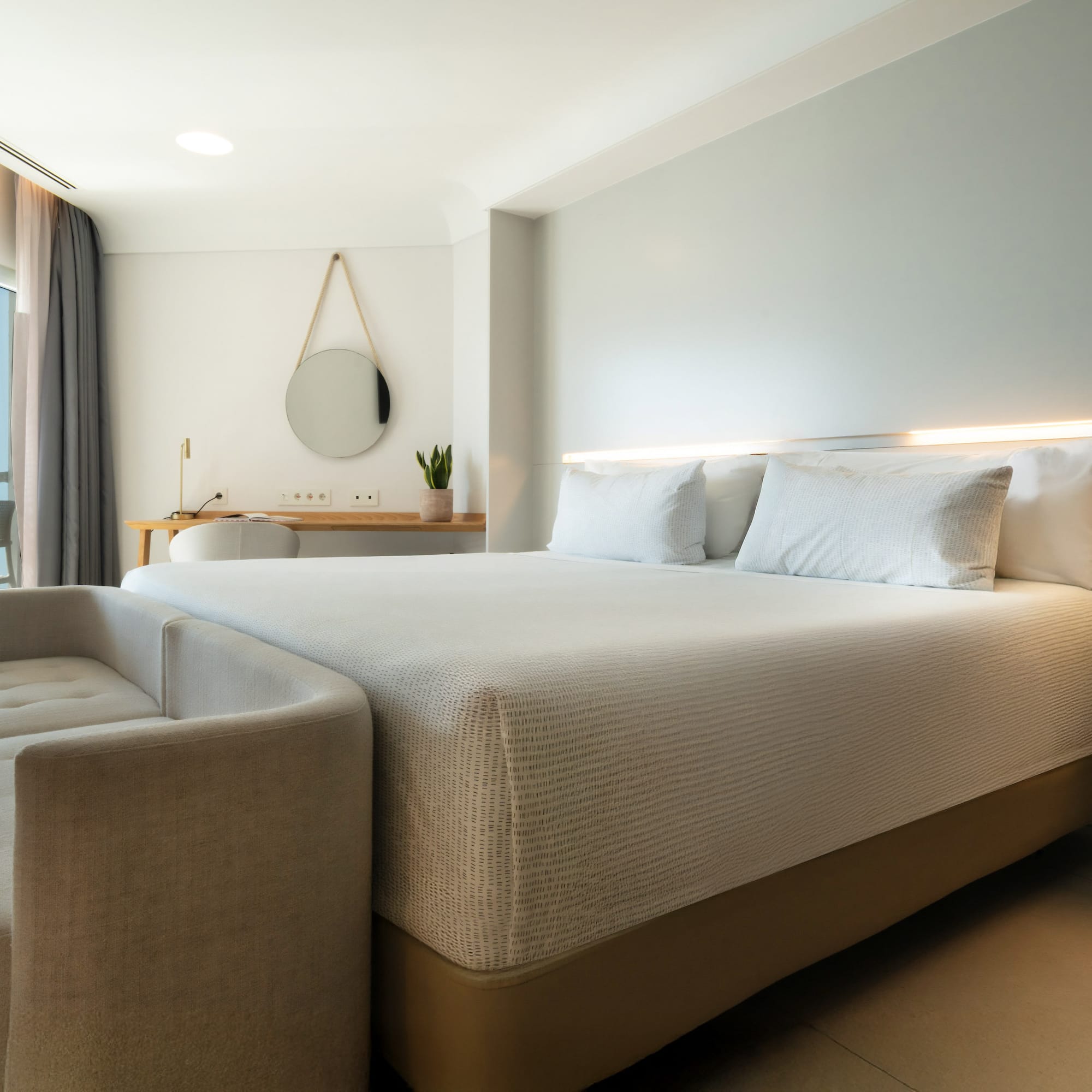 a bed with a couch in a room