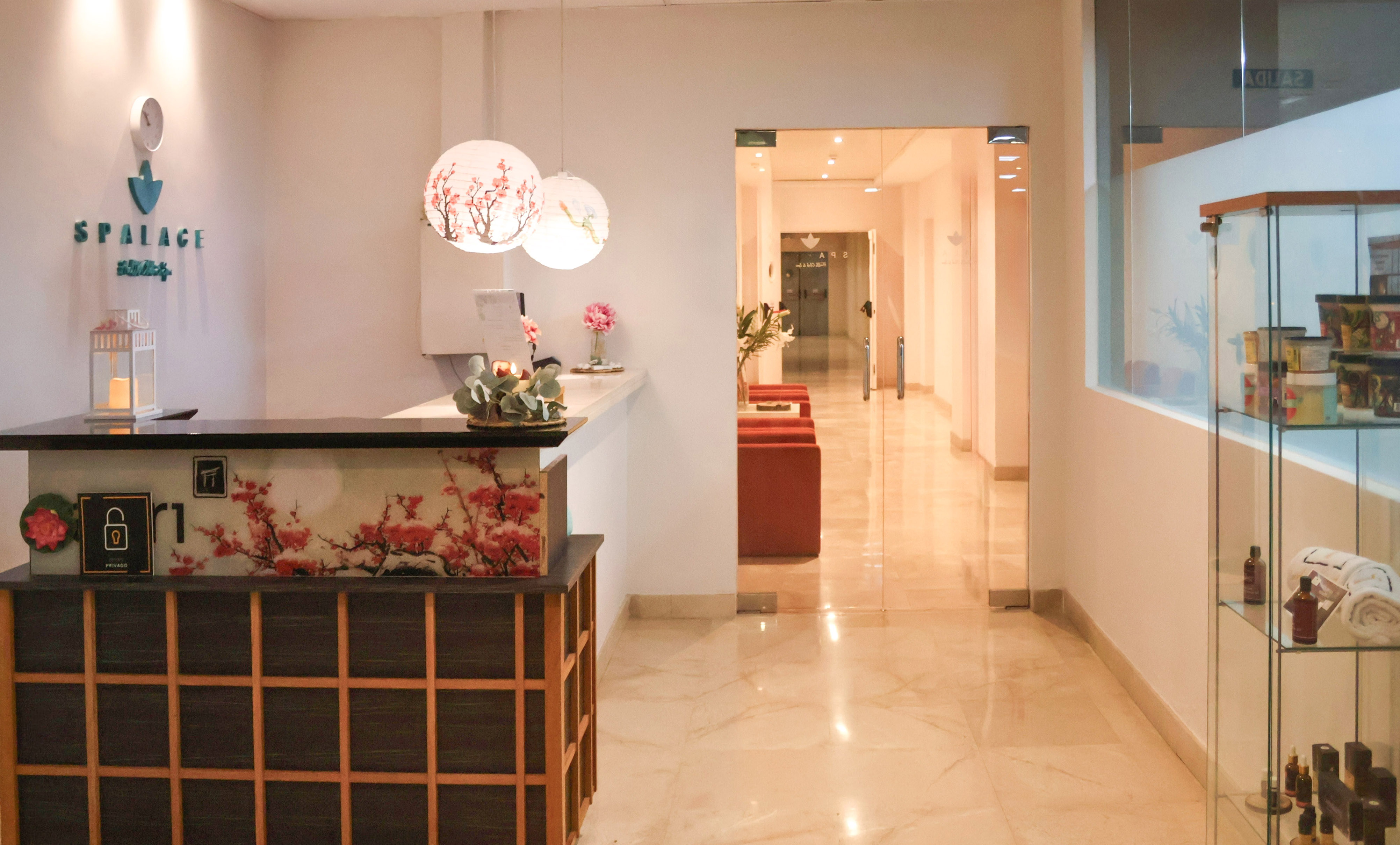 SPALACE spa reception desk, cherry blossom decor, and bright hallway interior.