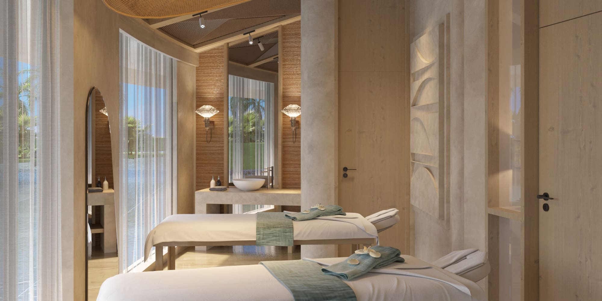 Luxury spa massage room with two beds, wooden accents, and tropical water view.