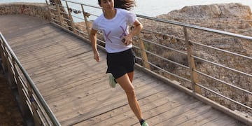 a woman running on a bridge