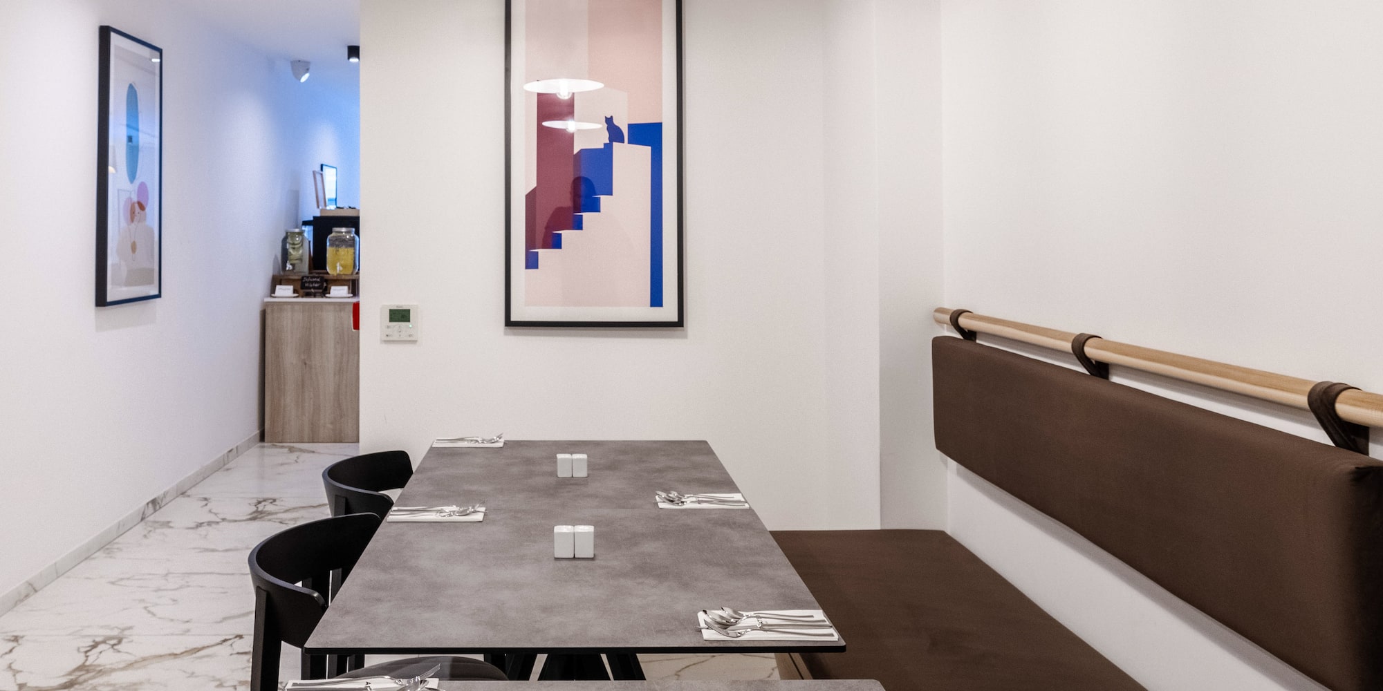 a table with brown seats and a white wall