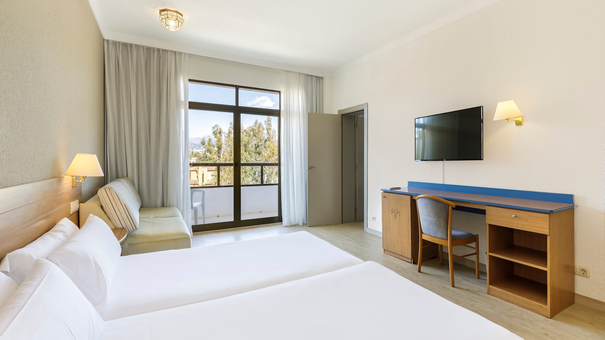 a room with two beds and a television