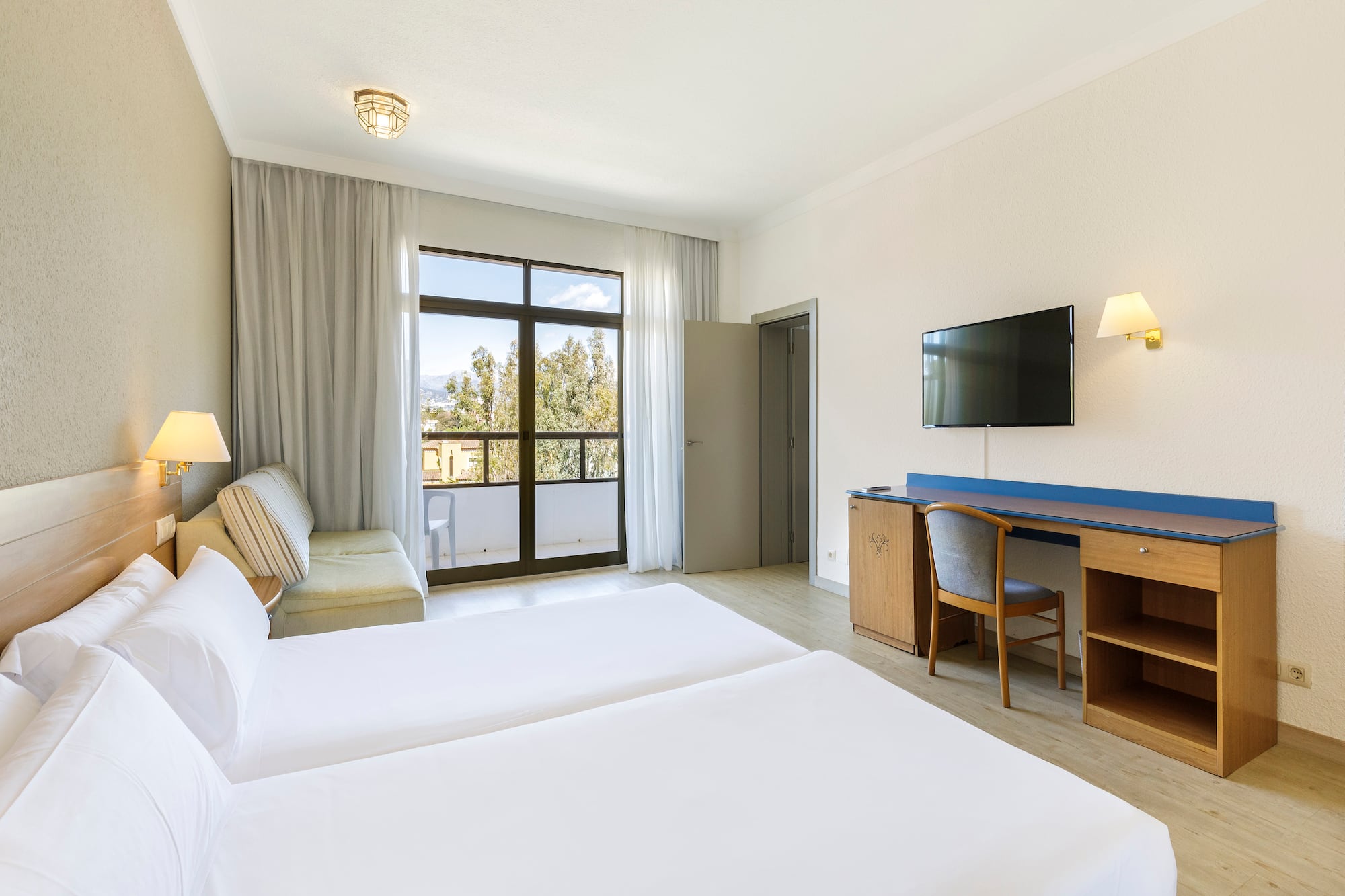 a room with two beds and a television