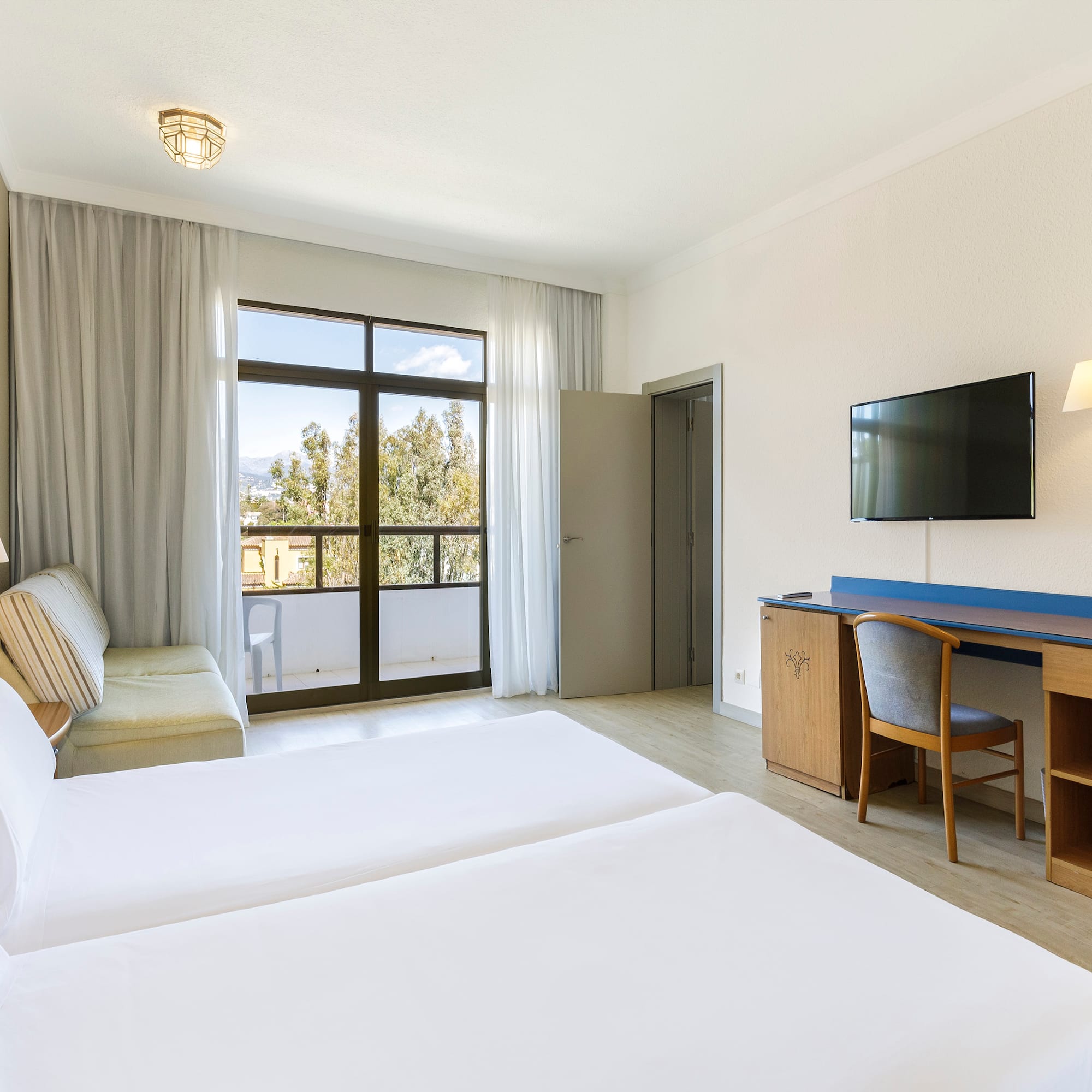 a room with two beds and a television