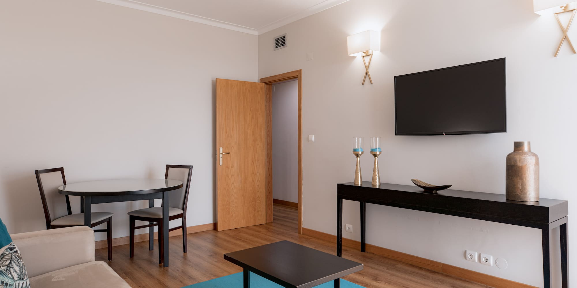 a living room with a table and a tv