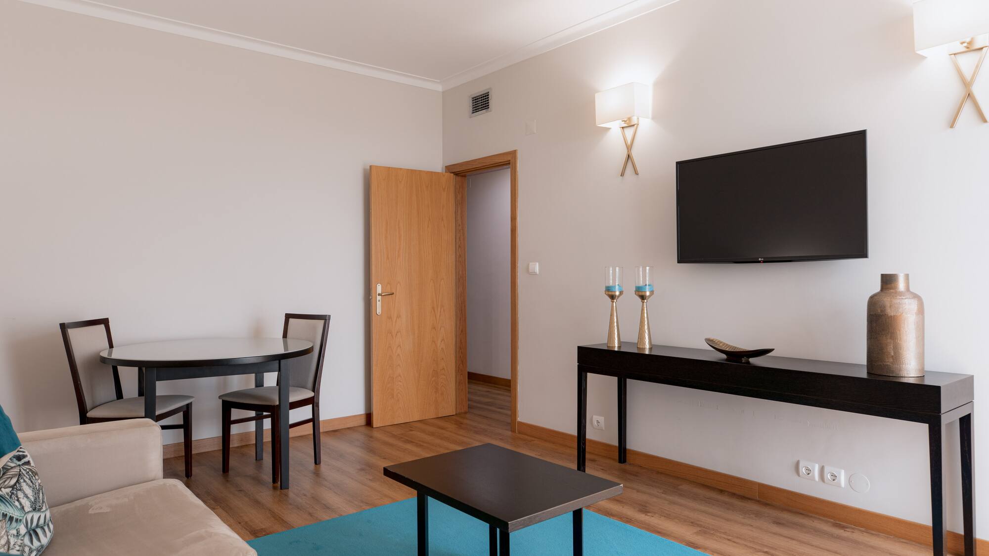 a living room with a table and a tv