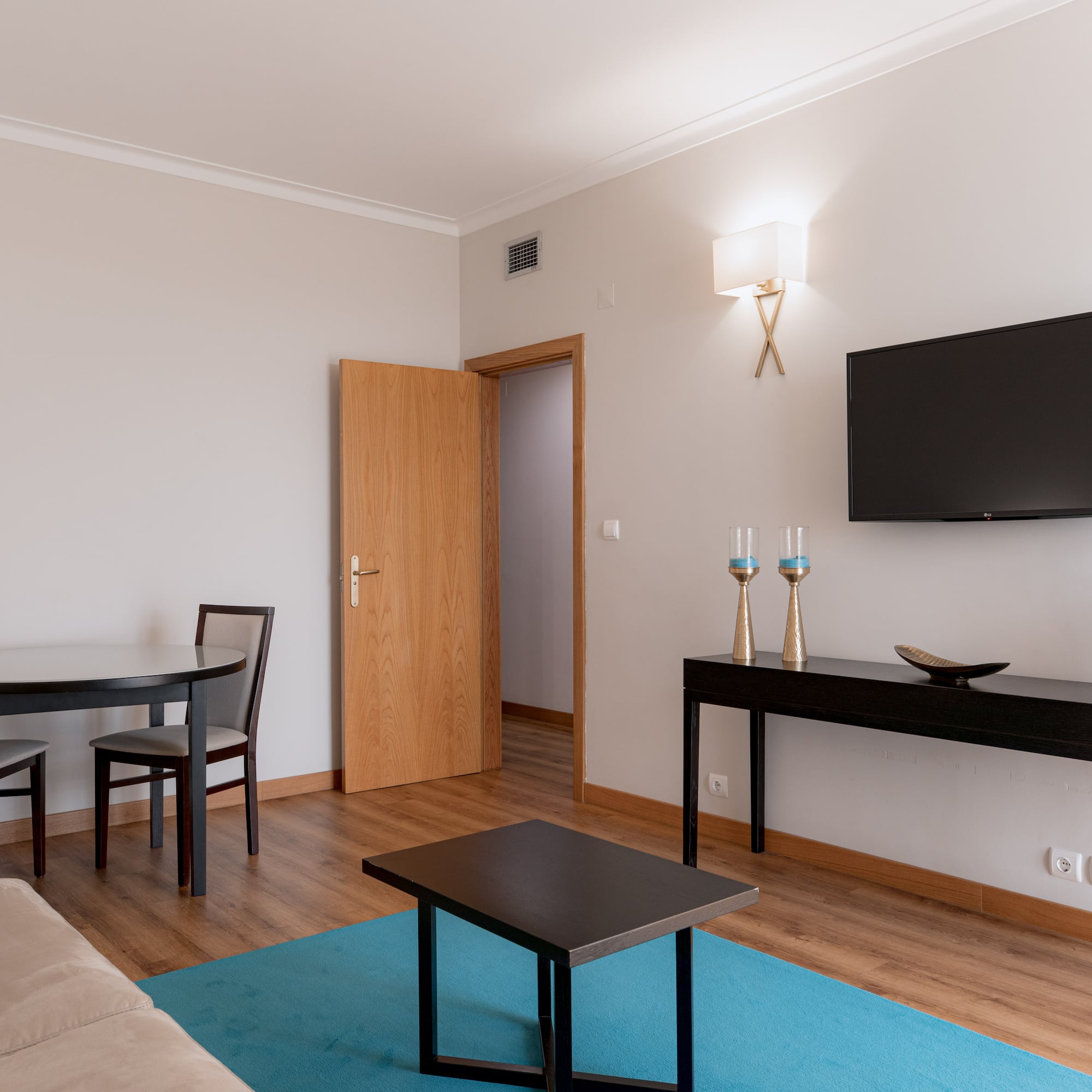 a living room with a table and a tv