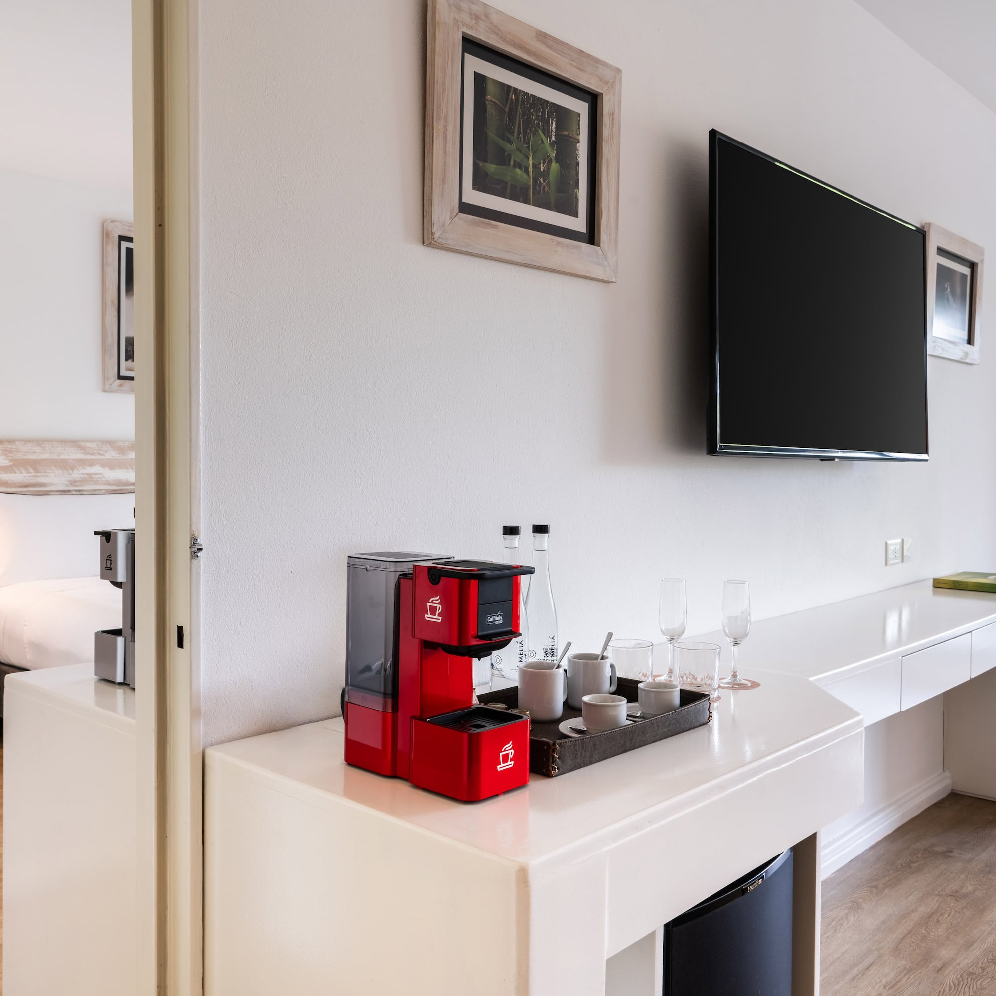 a room with a tv and a coffee maker