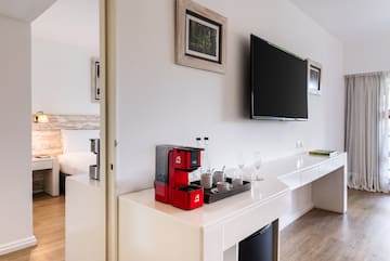 a room with a tv and a coffee maker
