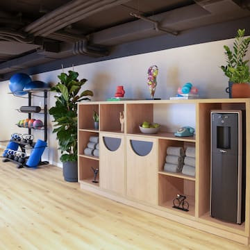 a room with shelves and gym equipment