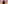 Maasai warrior in red shuka with spear, walking in savanna at sunset.