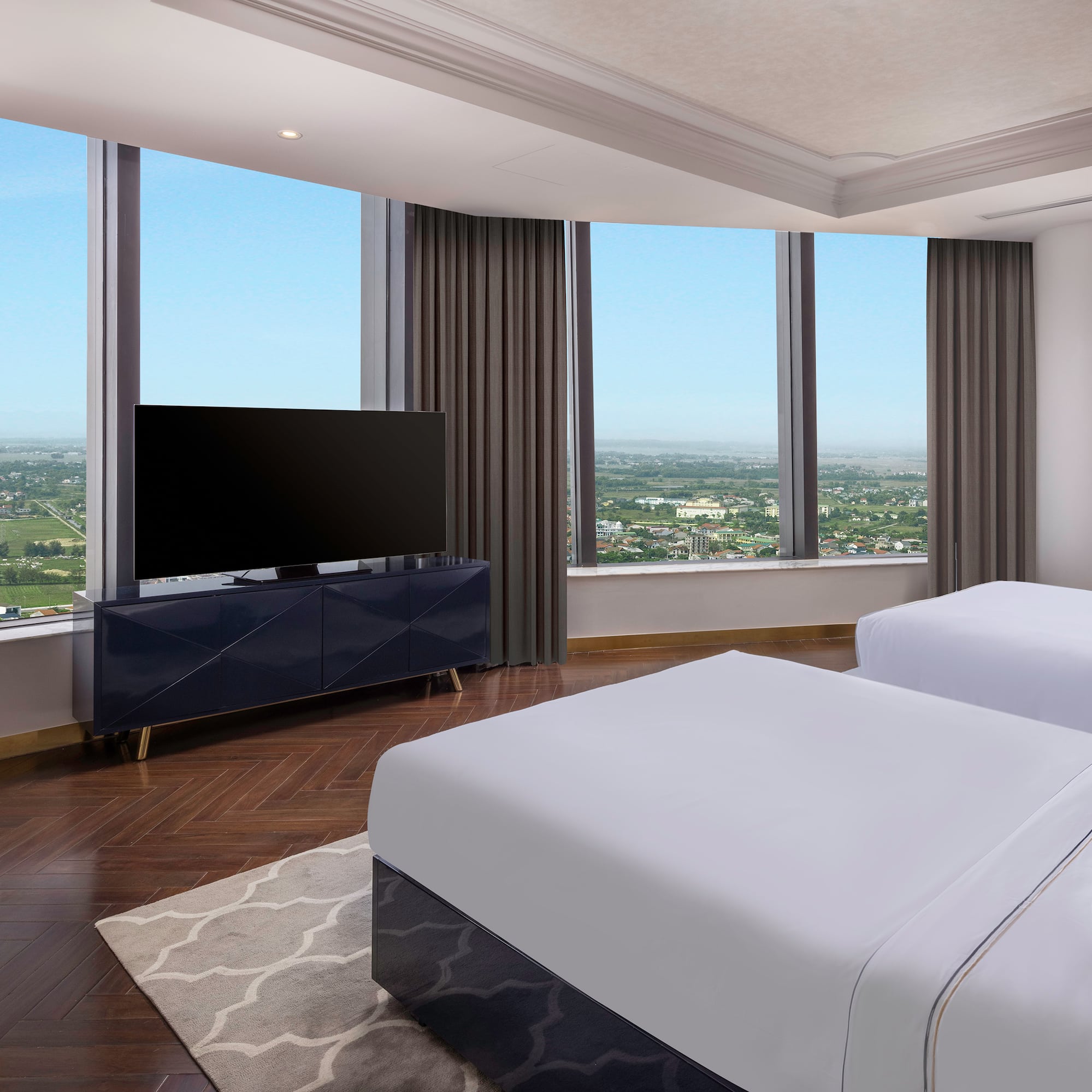 a room with two beds and a television