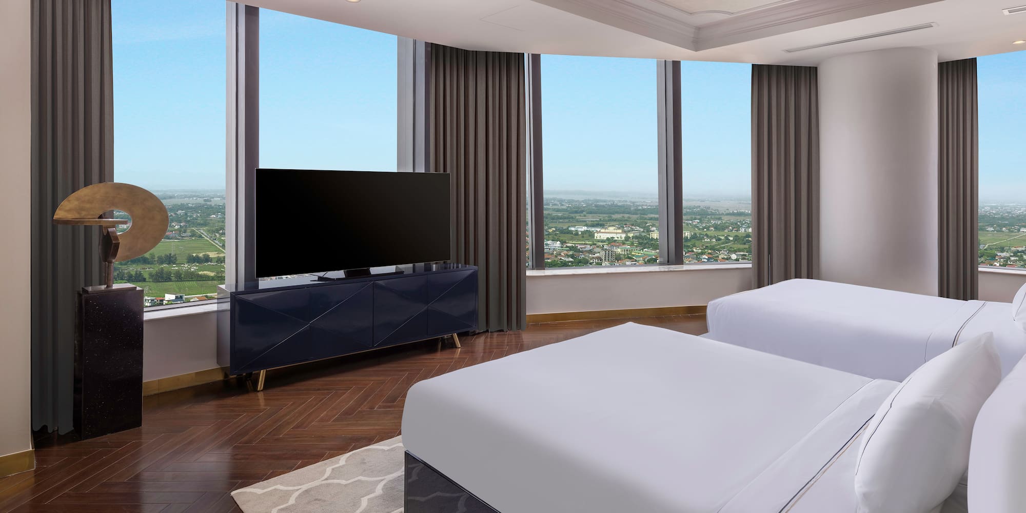 a room with two beds and a television