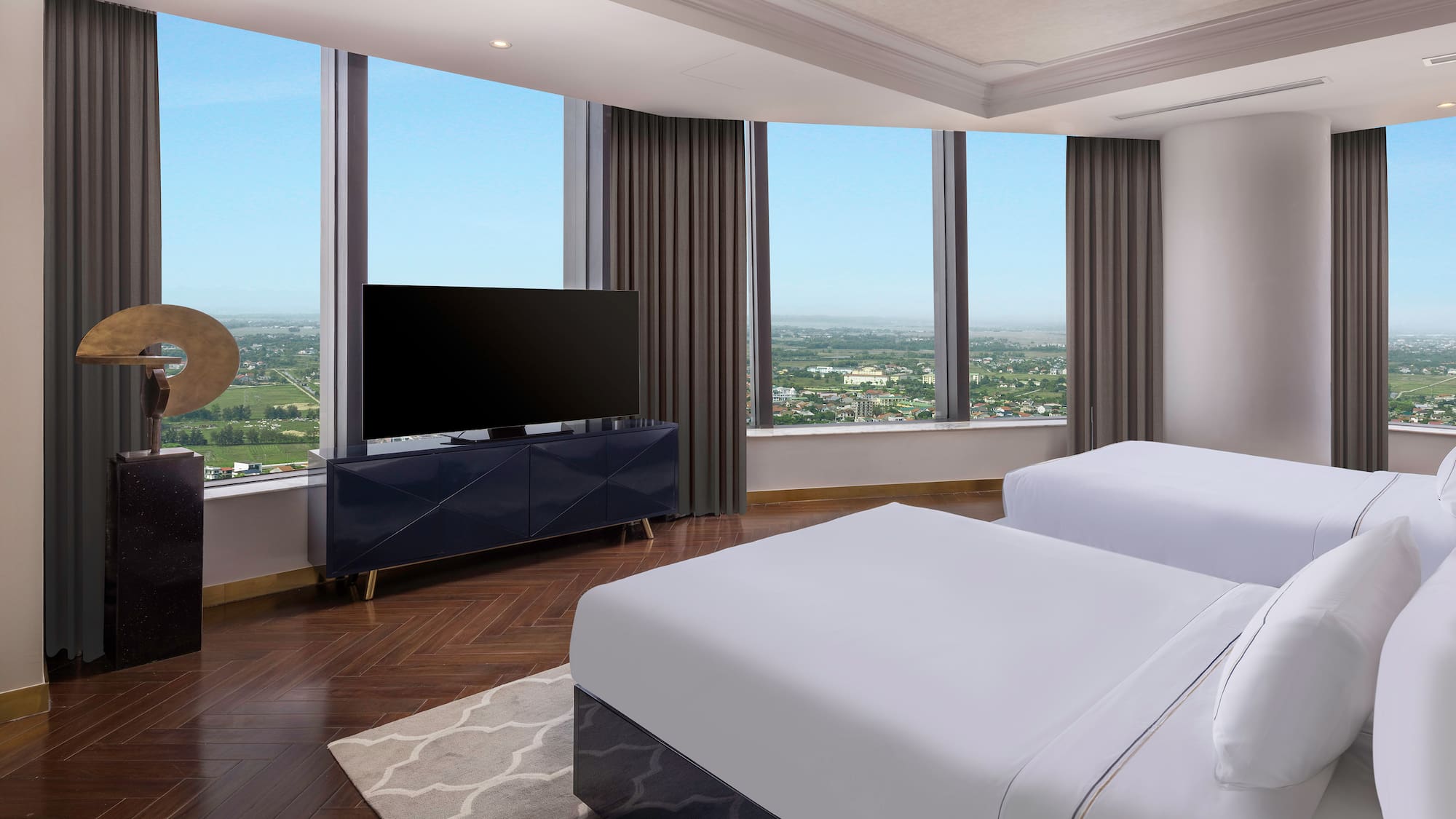 a room with two beds and a television