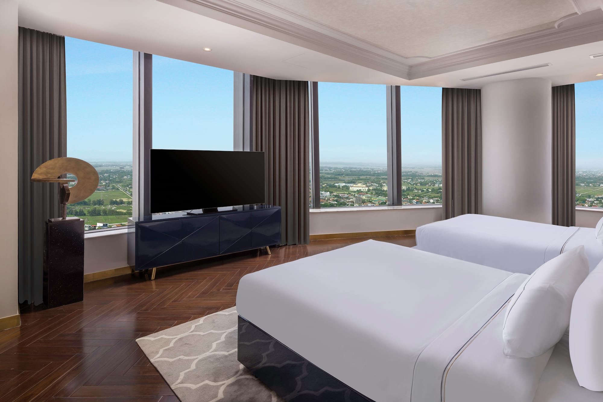 a room with two beds and a television