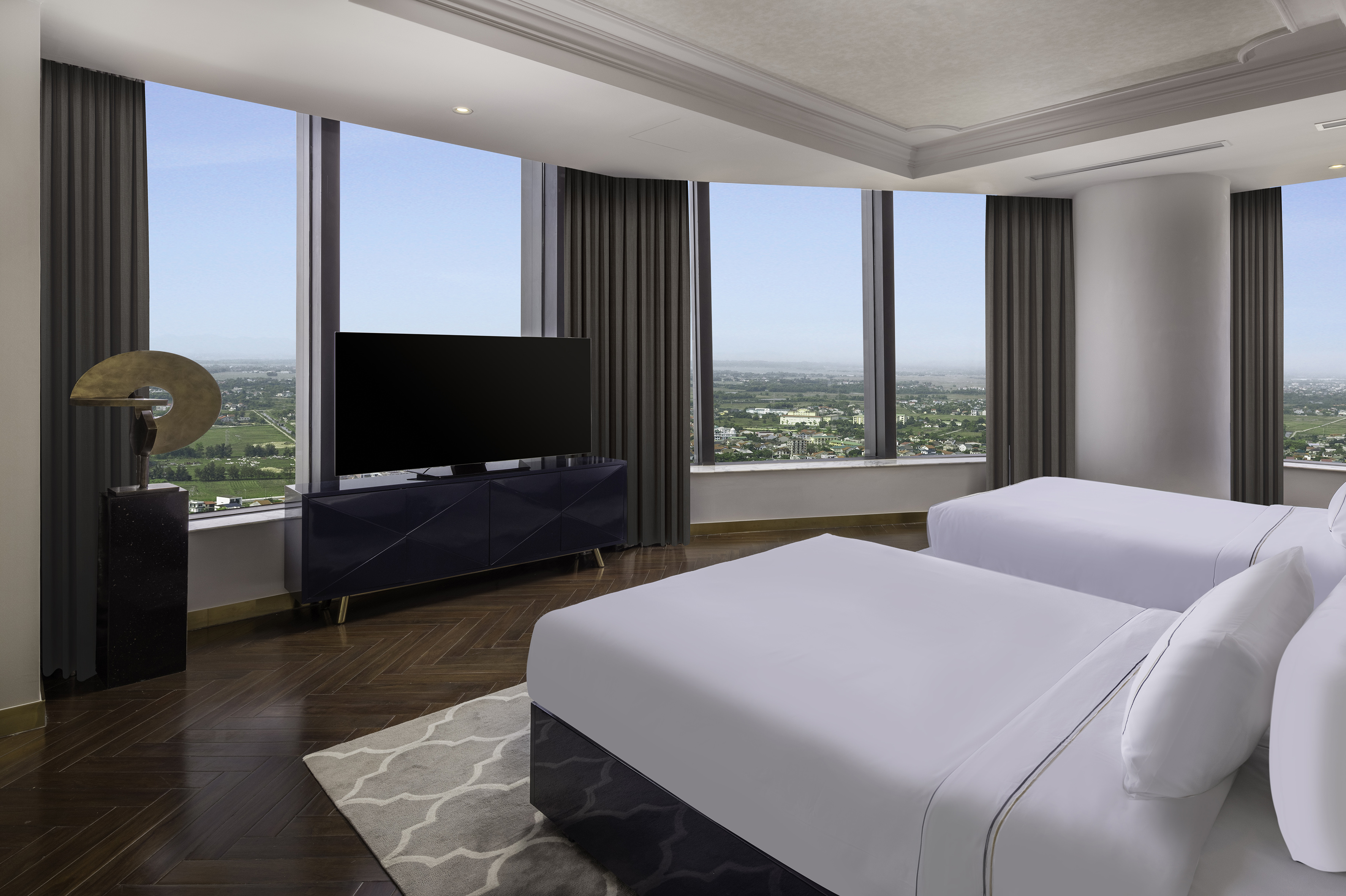 a room with two beds and a television