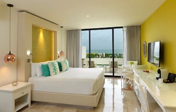 a room with a bed and a table and chairs