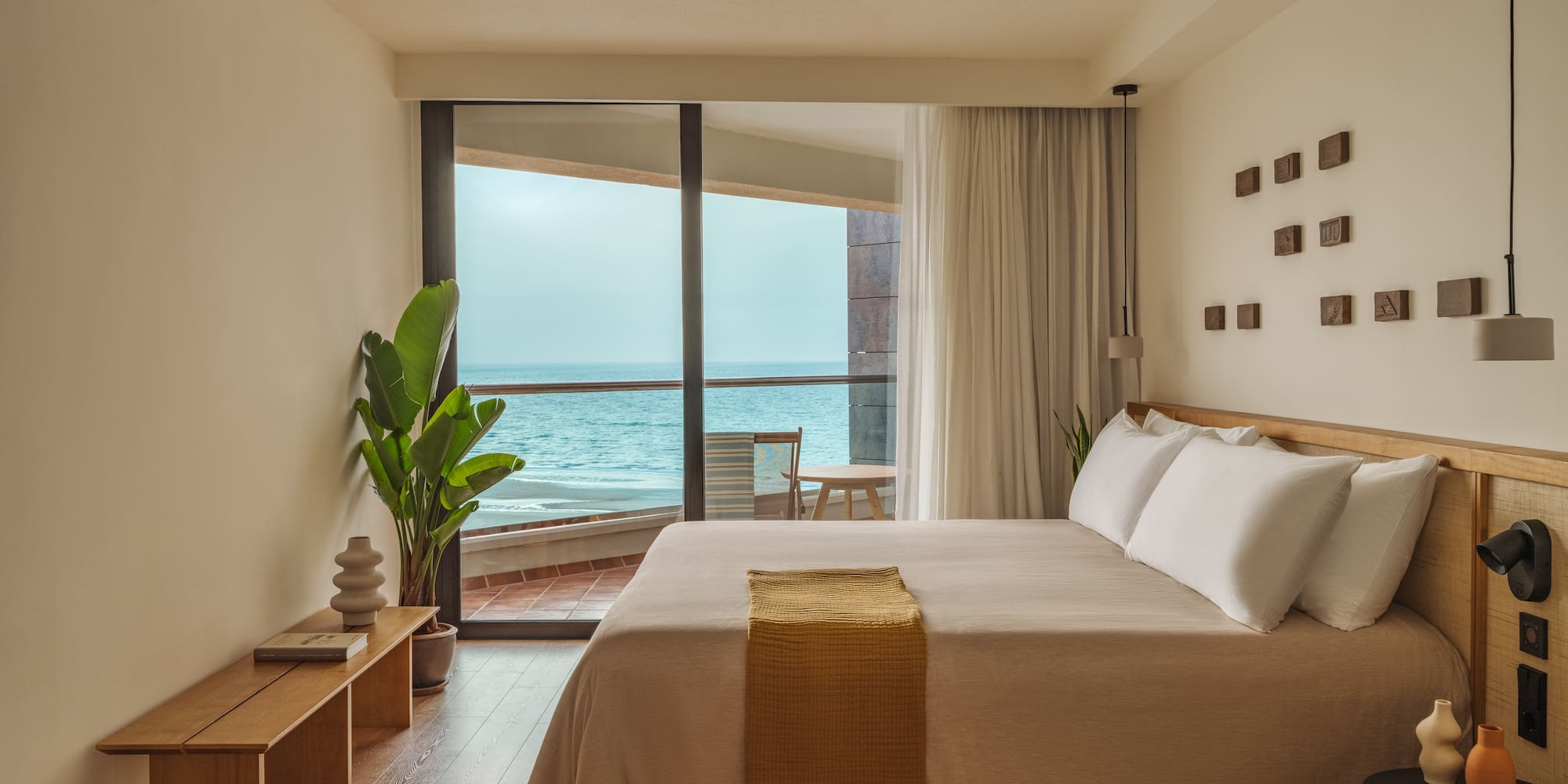 a bedroom with a large window overlooking the ocean