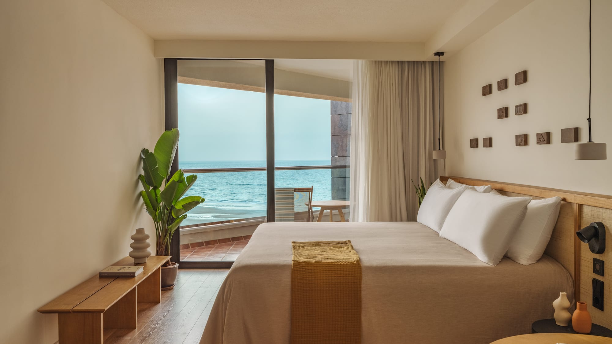 a bedroom with a large window overlooking the ocean