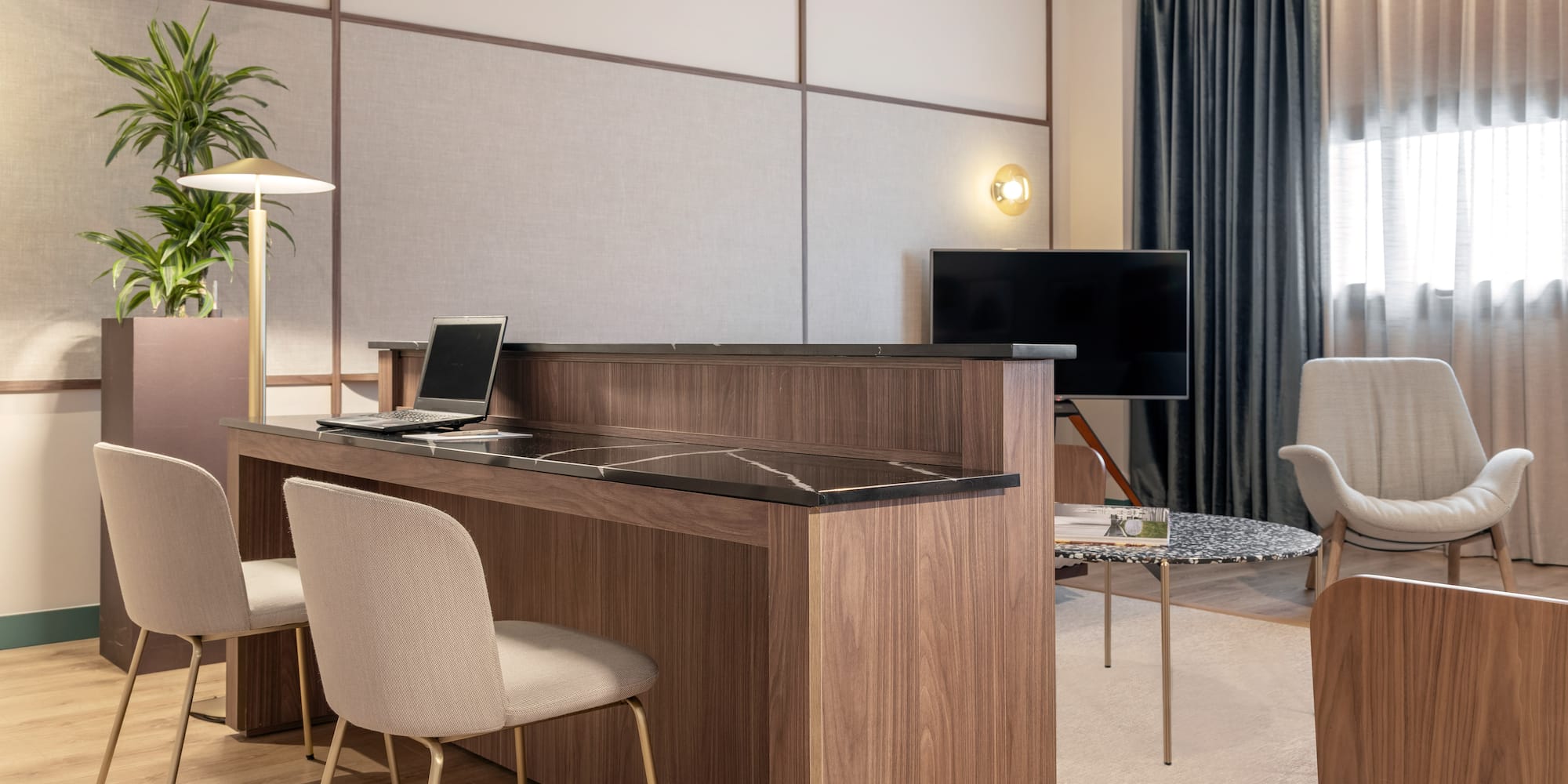 a room with a desk and chairs